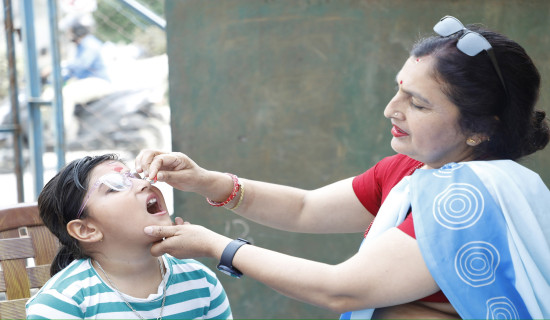 Vitamin 'A' capsules, de-worming tablets being administered to children