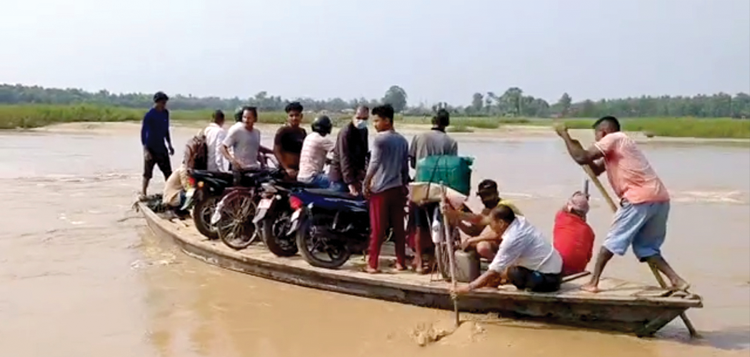 Locals compelled to use boats to cross flooded river in absence of bridge