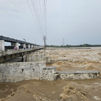 Struggling to cross inundated road