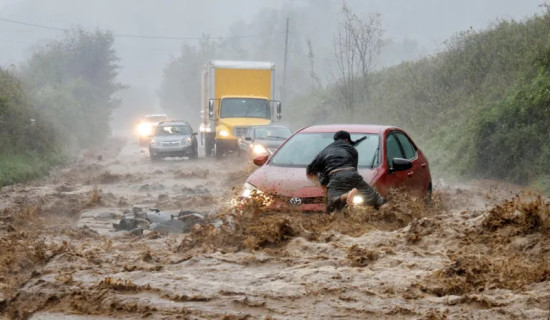 Struggling to cross inundated road