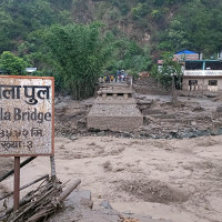 Struggling to cross inundated road