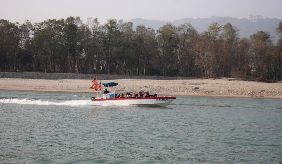 Tourists enjoy motorboat at Chitwan