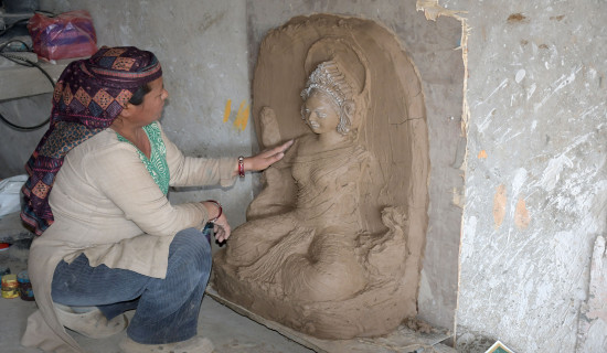 Artisan making idol of Goddess Saraswati