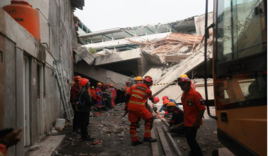 Rescuers run oxygen to survivors in Indonesia school building collapse that buried dozens