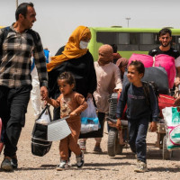 An Afghan family returns home from Iran after crossing the Islam Qala border in Afghanistan's Herat province in July 2025.  © UNHCR/Oxygen Empire Media Production